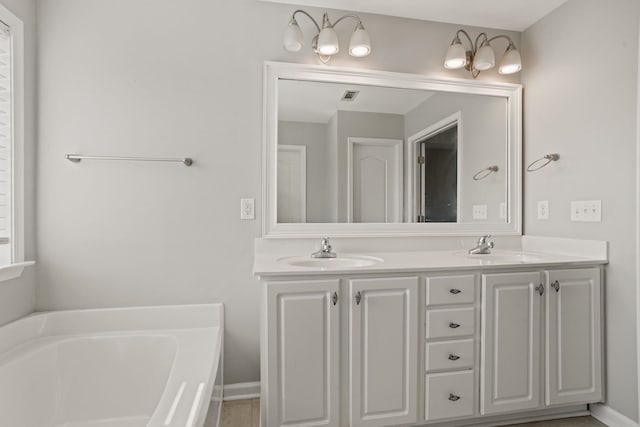 bathroom with a bath and vanity