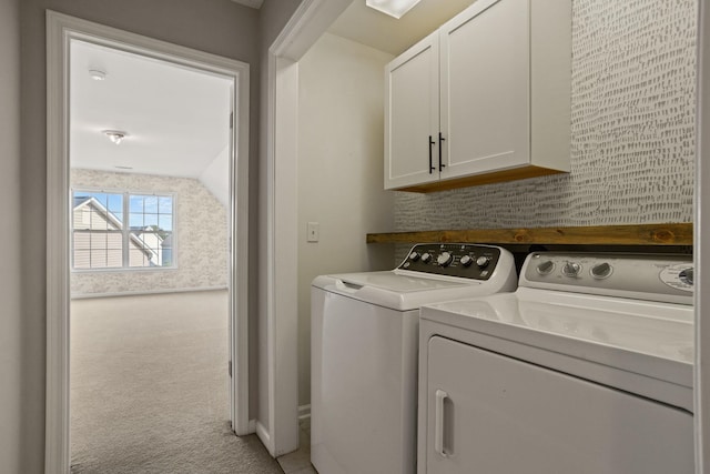 laundry area featuring light colored carpet, washing machine and dryer, and cabinets