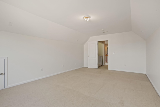 bonus room with light carpet and lofted ceiling