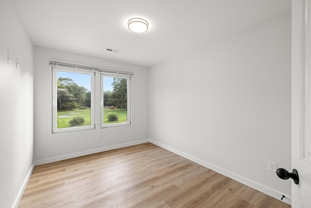 empty room with light hardwood / wood-style flooring