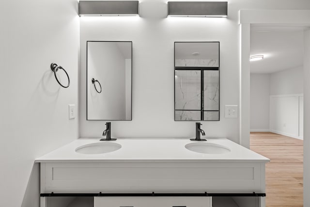 bathroom with hardwood / wood-style flooring and vanity