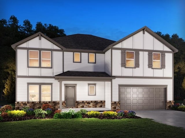 view of front of property with an attached garage, stone siding, a front lawn, and concrete driveway