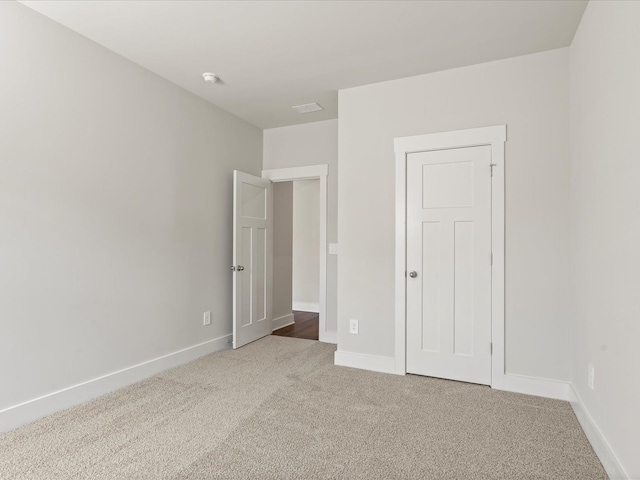 unfurnished bedroom featuring carpet floors and baseboards