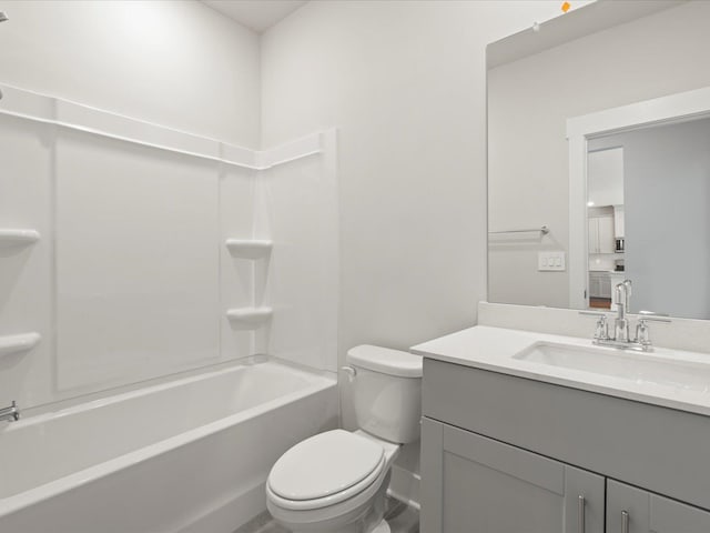 bathroom with bathtub / shower combination, vanity, and toilet