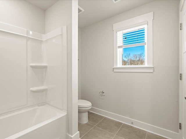 full bath with toilet, baseboards, and tile patterned floors