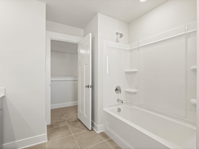 full bath featuring tile patterned flooring, baseboards, bathing tub / shower combination, and vanity