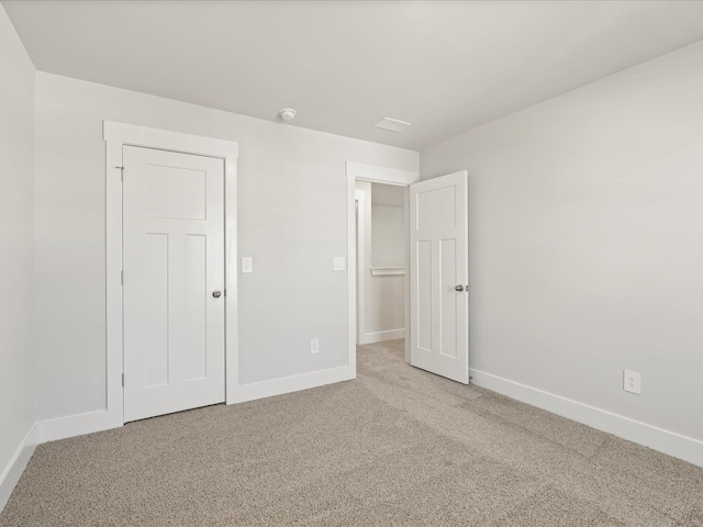 unfurnished bedroom featuring carpet floors and baseboards