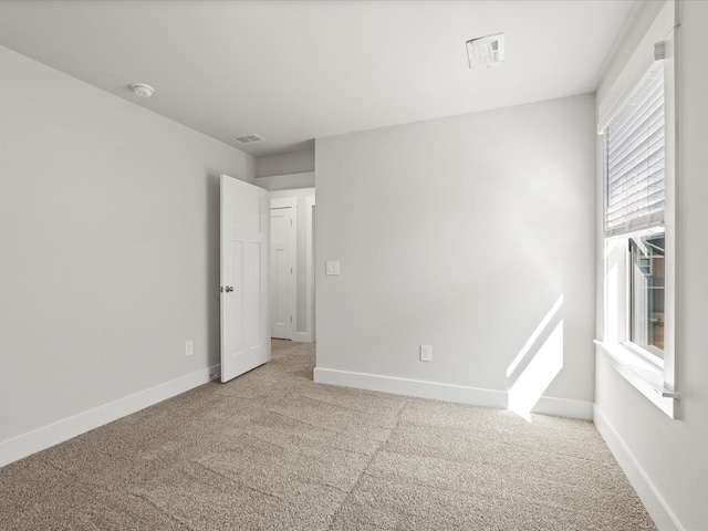 unfurnished bedroom featuring carpet, visible vents, and baseboards