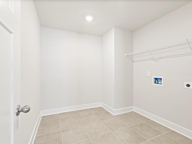 clothes washing area with laundry area, light tile patterned floors, baseboards, hookup for a washing machine, and electric dryer hookup