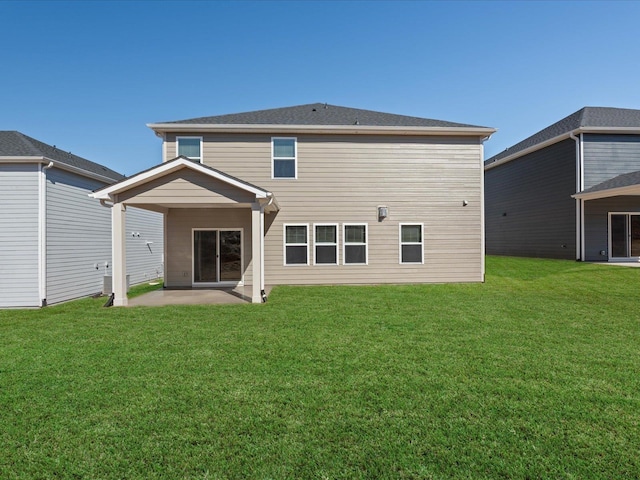 back of house featuring a patio area and a yard