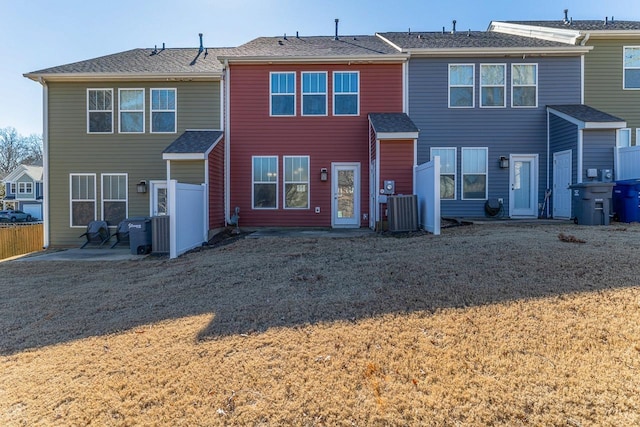 back of house with a patio area, cooling unit, and a lawn