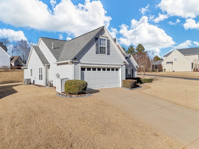 view of property exterior featuring central AC and a garage