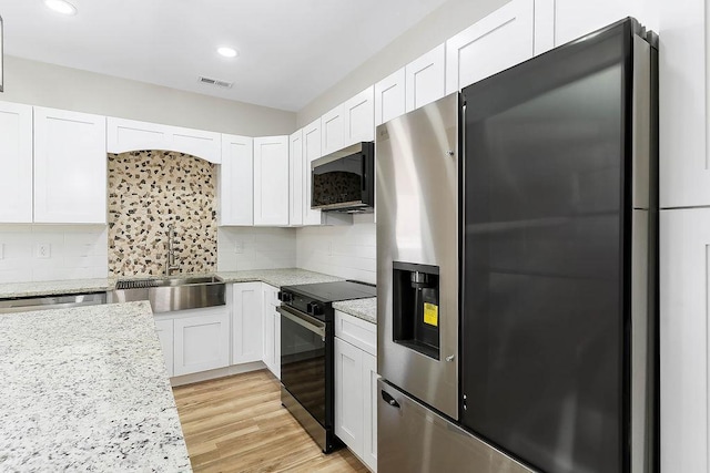 kitchen featuring white cabinets, black range with electric stovetop, sink, backsplash, and stainless steel fridge with ice dispenser