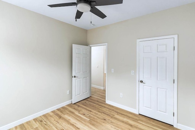 unfurnished bedroom with ceiling fan and light hardwood / wood-style flooring