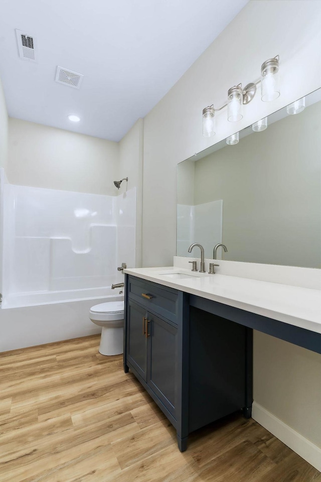 full bathroom featuring vanity, toilet, tub / shower combination, and wood-type flooring