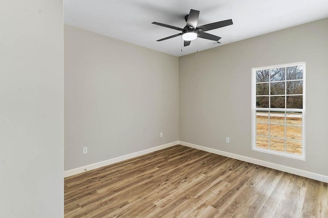 empty room featuring hardwood / wood-style flooring and ceiling fan