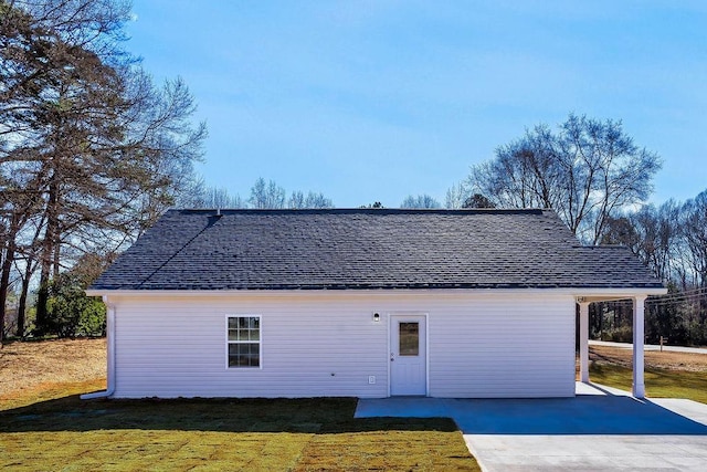 back of house featuring a yard and a carport