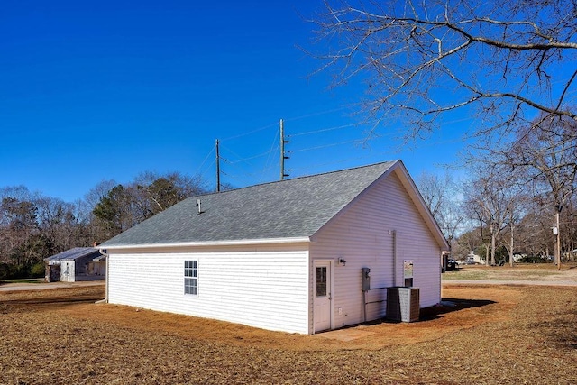 view of side of home with central air condition unit