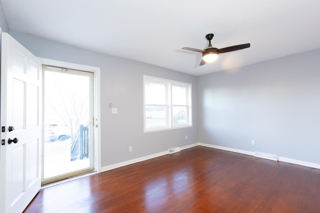 unfurnished room with dark hardwood / wood-style floors and ceiling fan