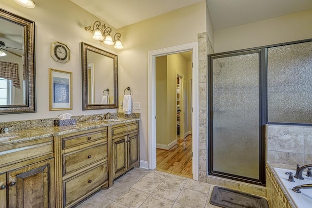 bathroom with independent shower and bath, tile patterned flooring, ceiling fan, and vanity