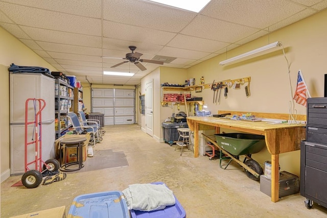 garage featuring ceiling fan and a workshop area