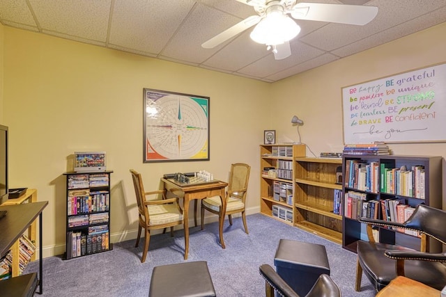 home office featuring a paneled ceiling, carpet flooring, and ceiling fan