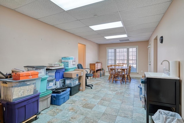 interior space with sink and a paneled ceiling