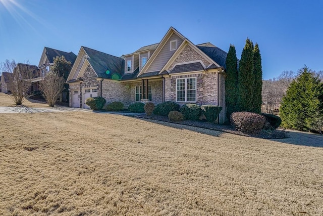 view of property with a garage and a front lawn