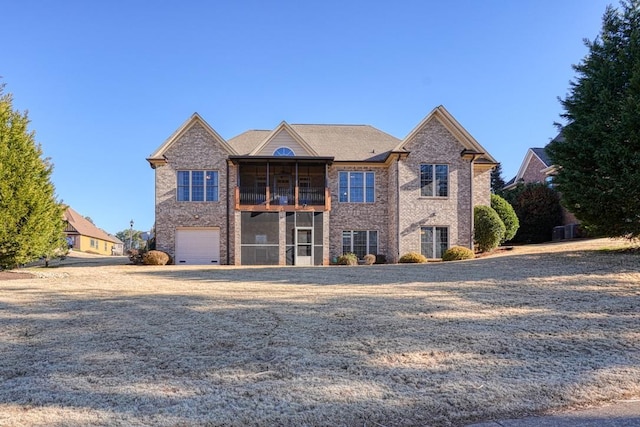 view of property featuring a garage and a sunroom