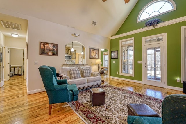 living room featuring high vaulted ceiling, light hardwood / wood-style flooring, and ceiling fan