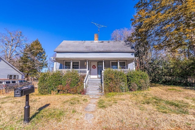 bungalow-style home with a front yard and a porch