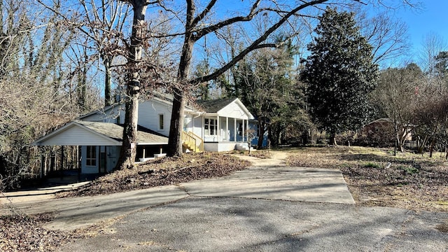 view of side of home featuring covered porch