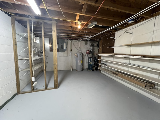 basement featuring electric water heater and electric panel