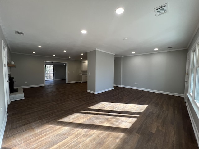 unfurnished living room featuring crown molding and dark hardwood / wood-style flooring