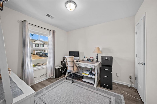 home office with dark wood-type flooring