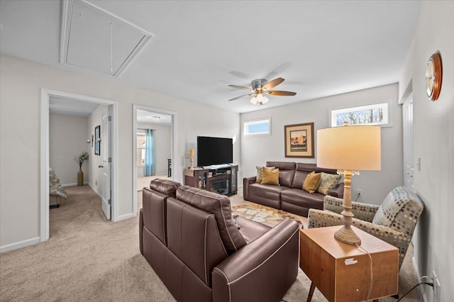 living room with light carpet, ceiling fan, and a wealth of natural light