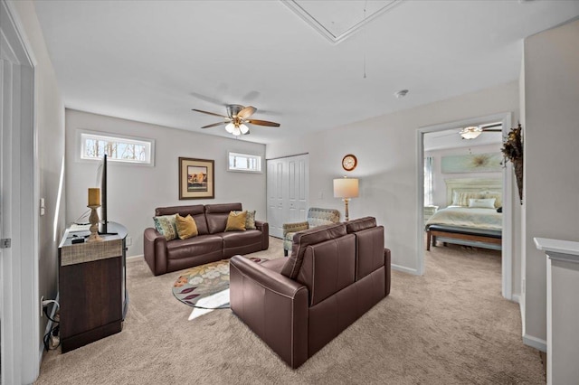 living room with ceiling fan and light colored carpet