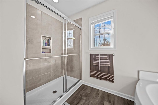 bathroom with wood-type flooring and walk in shower