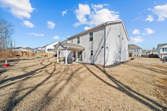 back of property with a patio and a yard