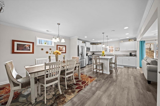 dining room featuring ornamental molding, an inviting chandelier, and dark hardwood / wood-style flooring