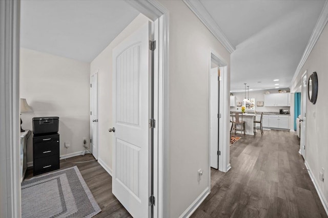 hallway with dark hardwood / wood-style flooring and crown molding