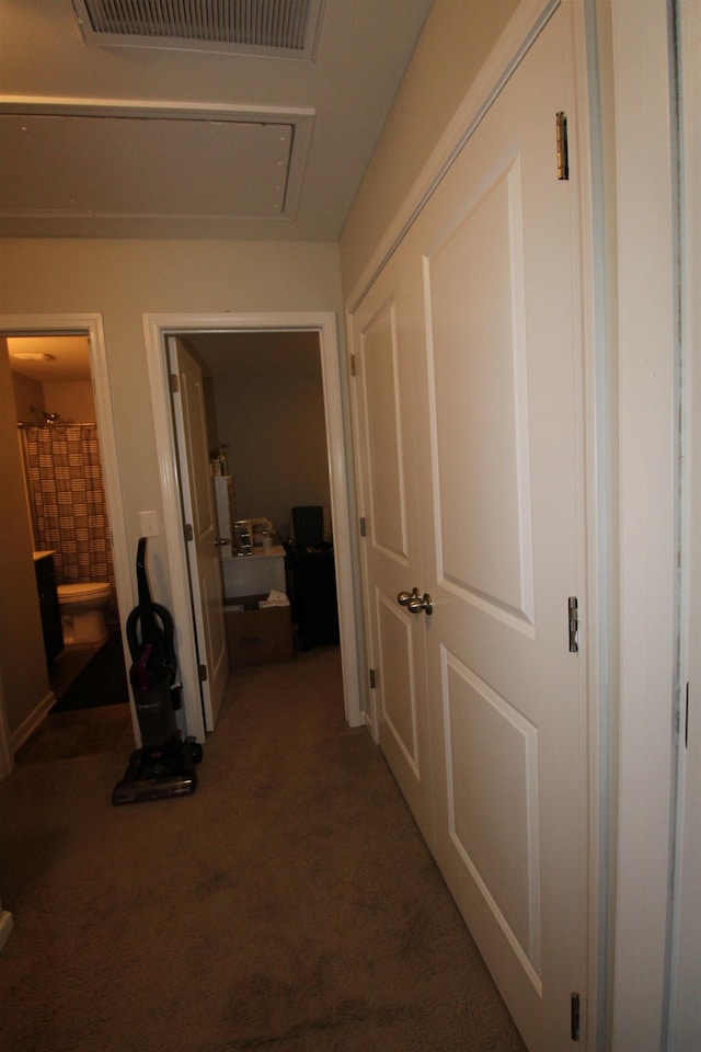 hallway with dark colored carpet