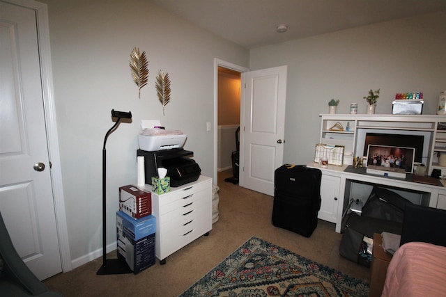 home office featuring a fireplace and light colored carpet