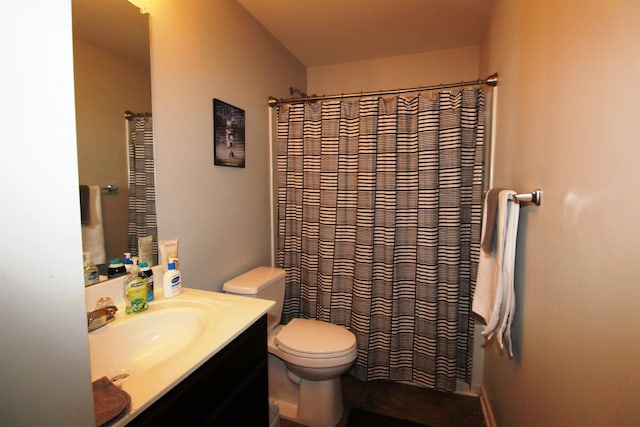 bathroom with vanity, toilet, and walk in shower