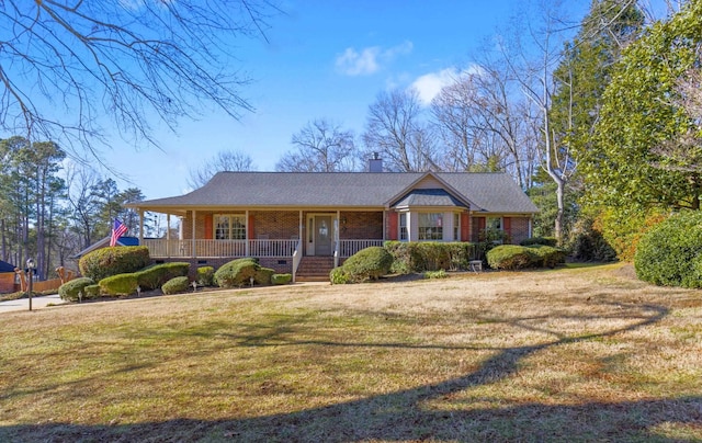 single story home featuring covered porch and a front lawn