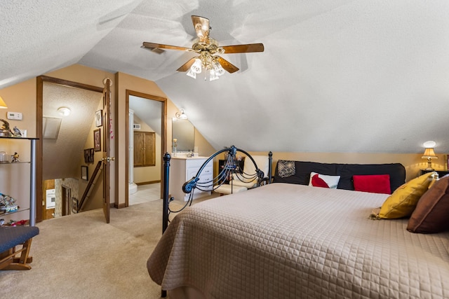 carpeted bedroom with lofted ceiling, a textured ceiling, and ceiling fan