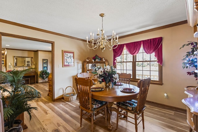 dining space with crown molding, wood-type flooring, an inviting chandelier, and a textured ceiling