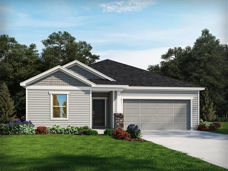 view of front of house with a garage and a front lawn