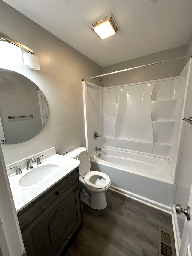 full bathroom with washtub / shower combination, wood-type flooring, toilet, and vanity