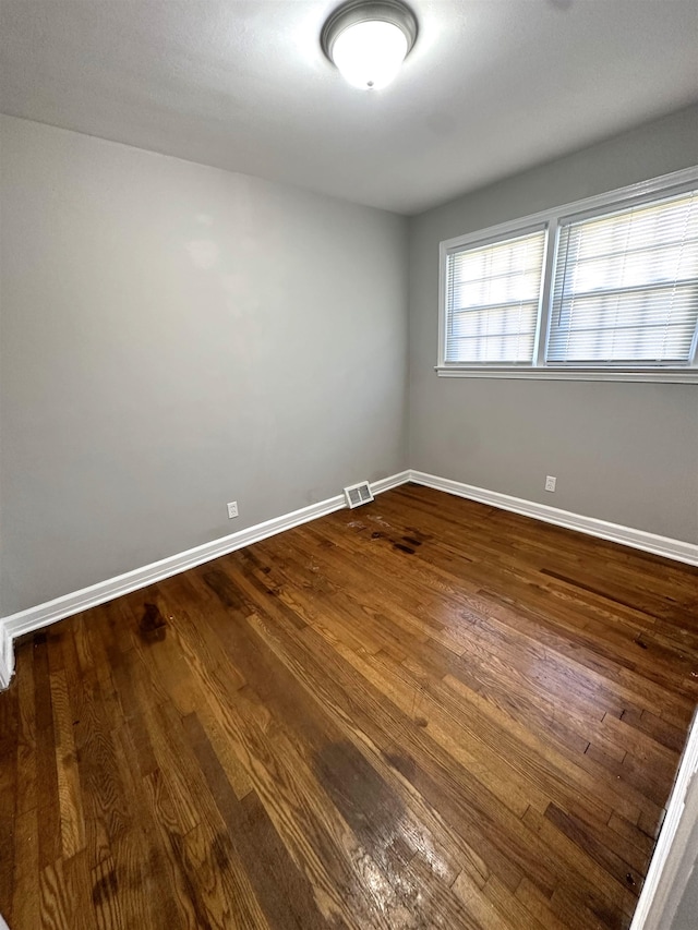 spare room with hardwood / wood-style floors